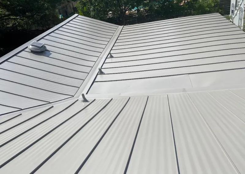 Solar attic fan installed on a metal roof for Roof Ventilation in Rumson